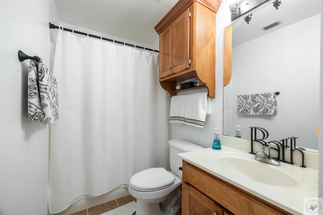 bathroom with curtained shower, toilet, tile patterned flooring, and vanity