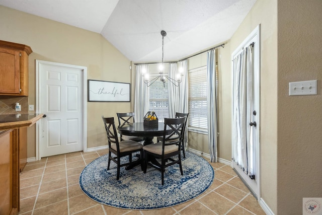 tiled dining space with a textured ceiling, a notable chandelier, and lofted ceiling