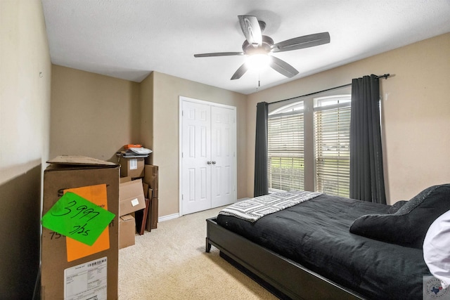 carpeted bedroom with a closet and ceiling fan