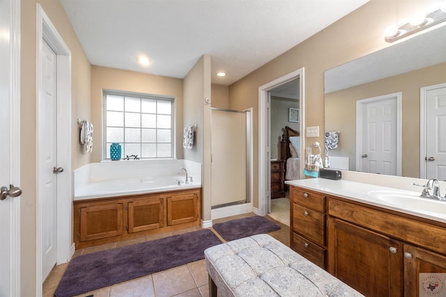 bathroom with vanity, tile patterned floors, and plus walk in shower