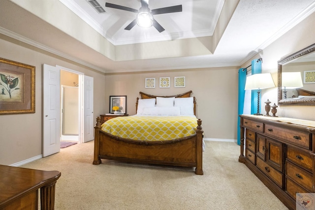 bedroom featuring ceiling fan, light colored carpet, a tray ceiling, and ornamental molding