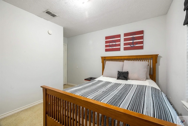 carpeted bedroom featuring a textured ceiling