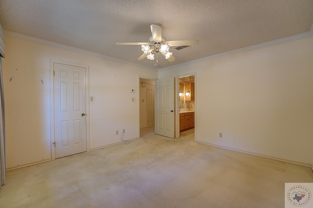 unfurnished bedroom featuring ceiling fan, connected bathroom, ornamental molding, and a textured ceiling