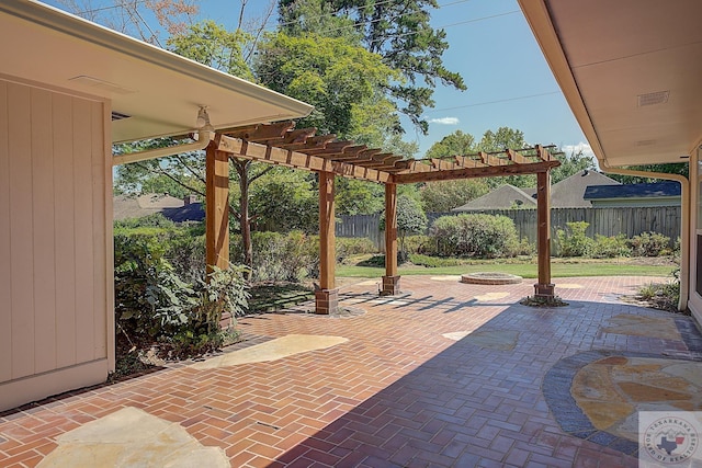 view of patio / terrace with an outdoor fire pit and a pergola