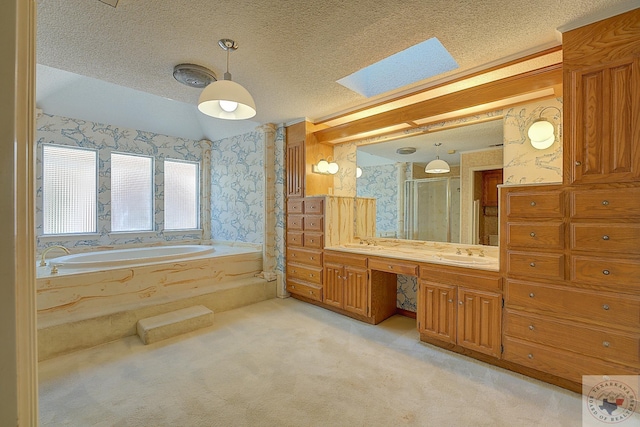 bathroom with vanity, a textured ceiling, separate shower and tub, and vaulted ceiling with skylight