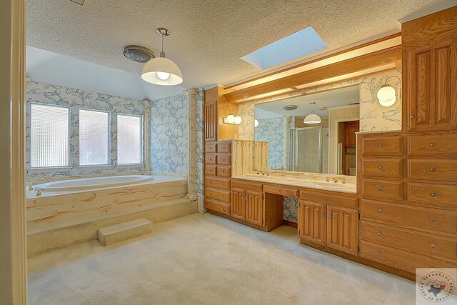 bathroom with vanity, a textured ceiling, separate shower and tub, and vaulted ceiling with skylight