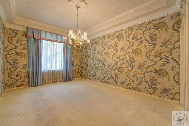 carpeted spare room featuring crown molding and a notable chandelier