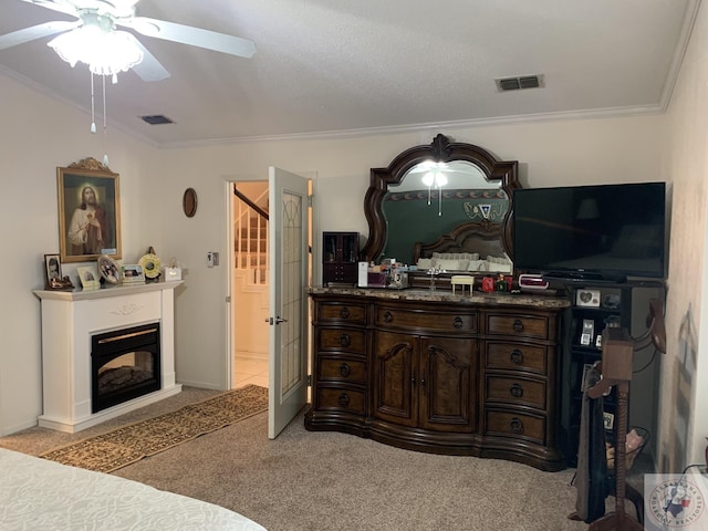 carpeted bedroom featuring ceiling fan and ornamental molding