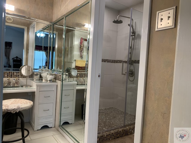 bathroom with tasteful backsplash, tile patterned floors, and an enclosed shower