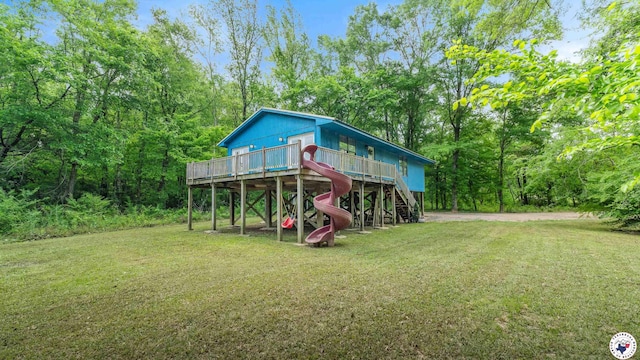 22 Elmwood Ln, Texarkana, TX 75501 - exterior space featuring a wooden deck, a lawn, a wooded view, and stairs