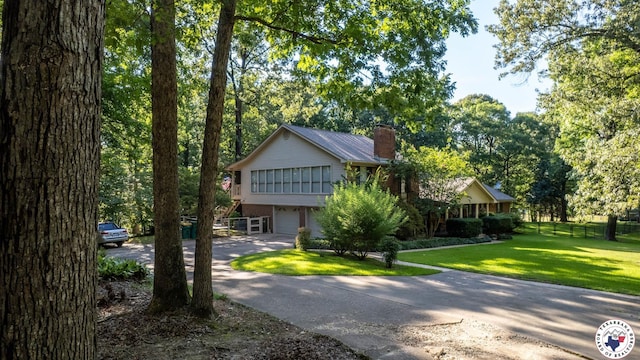 6 High Point Dr, Texarkana, TX 75503 - view of front of property featuring a chimney, a garage, and driveway