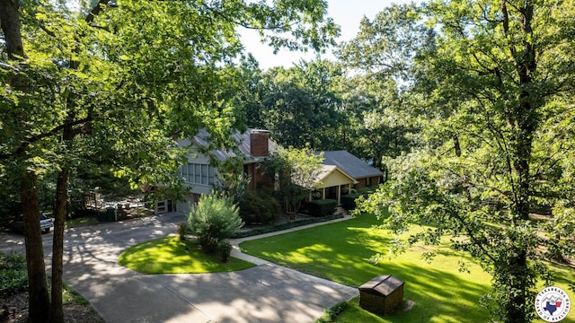 6 High Point Dr, Texarkana, TX 75503 - view of front of property with a front yard, a chimney, concrete driveway, and a garage