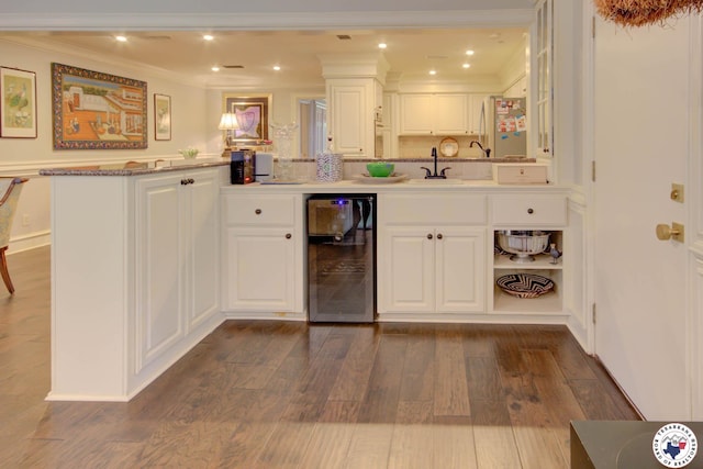 6 High Point Dr, Texarkana, TX 75503 - kitchen with beverage cooler, dark wood-style floors, crown molding, white cabinetry, and recessed lighting