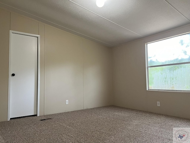 119 Krobot Cir, Texarkana, TX 75503 - carpeted empty room with a textured ceiling