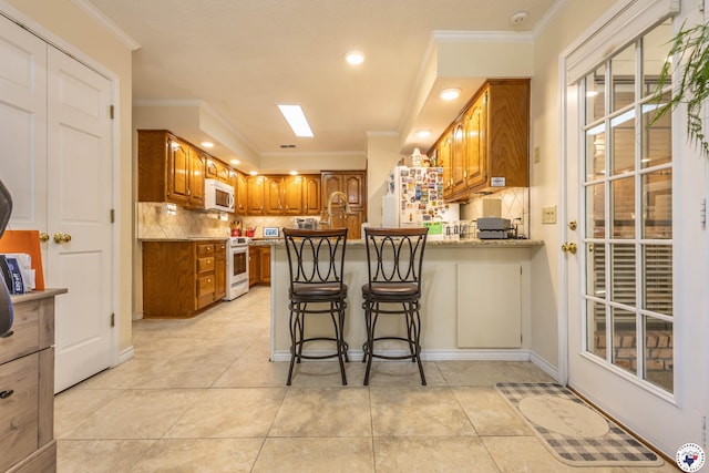 505 Langford Ln, New Boston, TX 75570 - kitchen with white appliances, brown cabinetry, a peninsula, ornamental molding, and tasteful backsplash