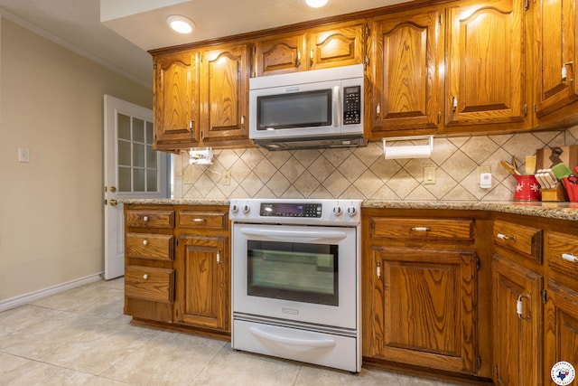 505 Langford Ln, New Boston, TX 75570 - kitchen featuring stainless steel microwave, electric range oven, brown cabinetry, ornamental molding, and backsplash
