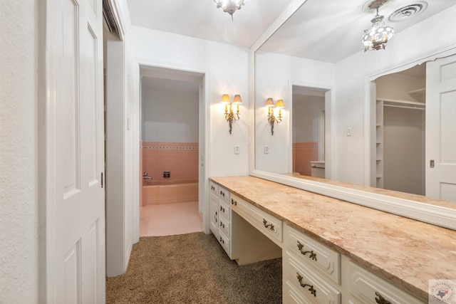 bathroom with a tub to relax in and vanity