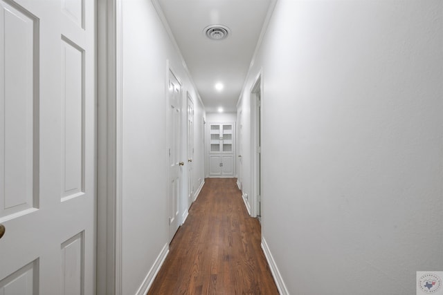 hall with crown molding and dark hardwood / wood-style floors