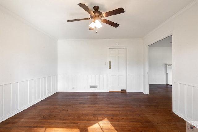 empty room featuring ceiling fan, dark wood-type flooring, and crown molding