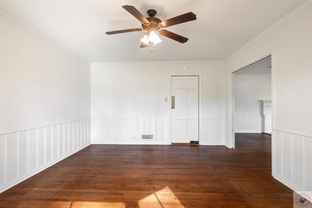 empty room featuring ceiling fan, dark wood-type flooring, and crown molding