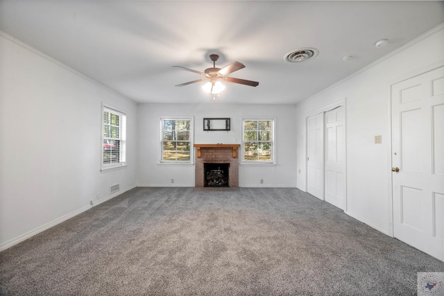 unfurnished living room with a fireplace, carpet floors, ceiling fan, and ornamental molding