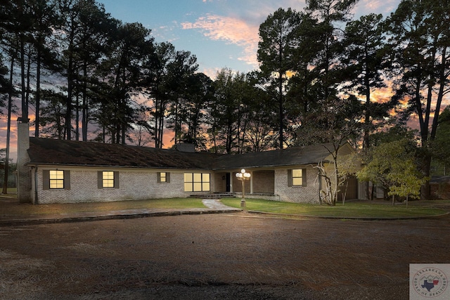 ranch-style house featuring a lawn