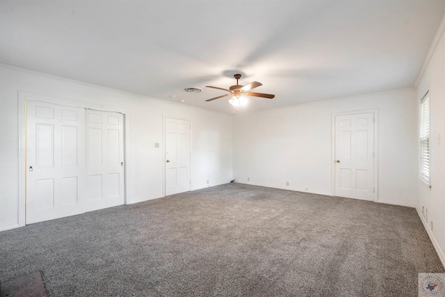 unfurnished bedroom with multiple closets, ceiling fan, carpet flooring, and ornamental molding