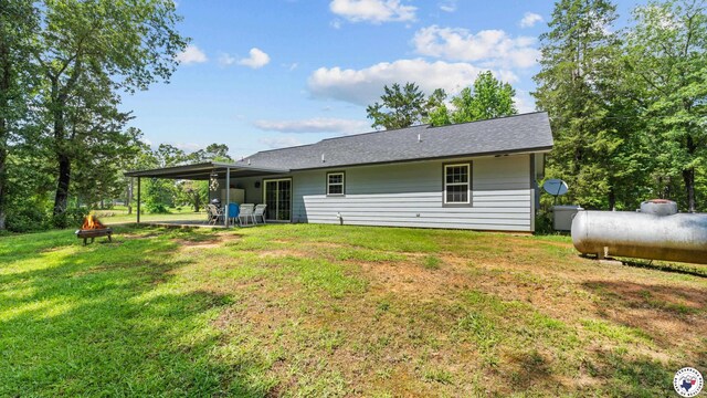 242 County Road 4228, Atlanta, TX 75551 - rear view of house with a yard and an attached carport