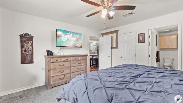 242 County Road 4228, Atlanta, TX 75551 - bedroom with light carpet, baseboards, connected bathroom, and ceiling fan