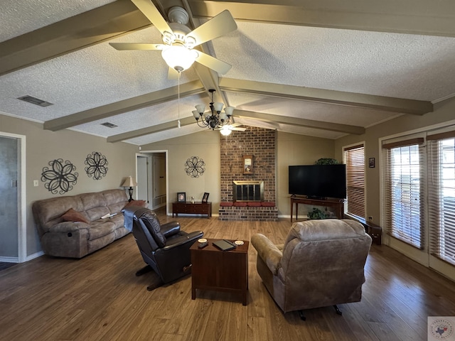 living room featuring a brick fireplace, a textured ceiling, lofted ceiling with beams, and wood finished floors