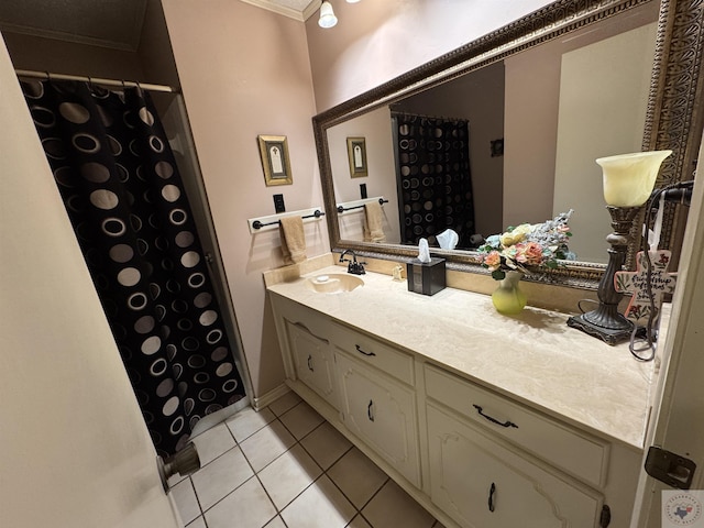 bathroom featuring tile patterned flooring, ornamental molding, and vanity