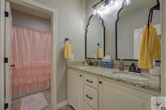 bathroom with tile patterned floors and vanity