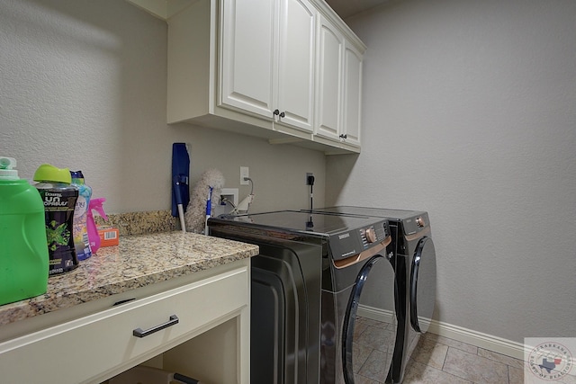 washroom with cabinets, light tile patterned floors, and independent washer and dryer