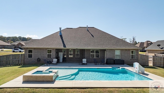 view of swimming pool with an in ground hot tub, a yard, and a patio