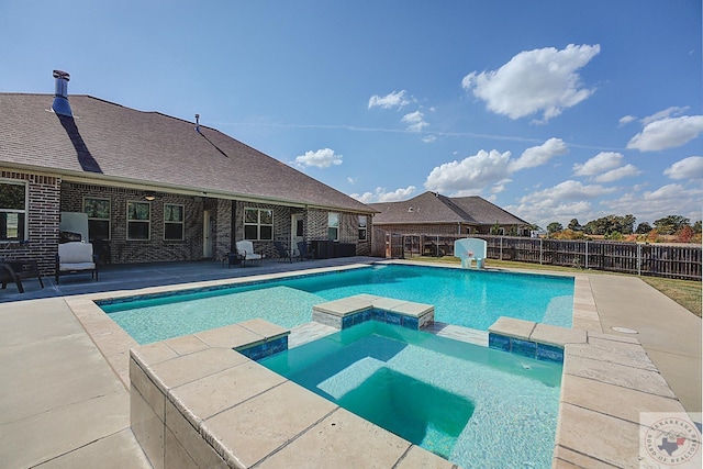 view of pool with an in ground hot tub and a patio