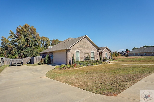 view of front of home featuring a front yard and a garage