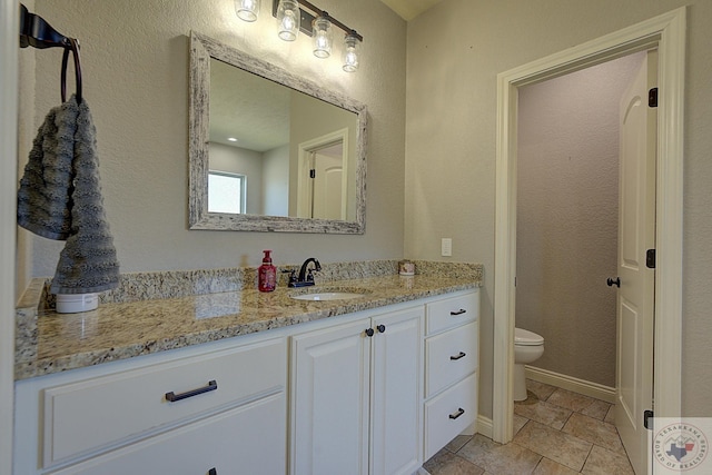 bathroom with toilet and vanity