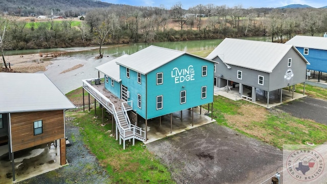 birds eye view of property with a water and mountain view