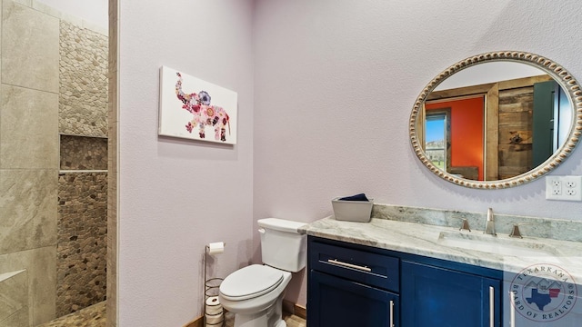 full bath with a walk in shower, a textured wall, toilet, and vanity