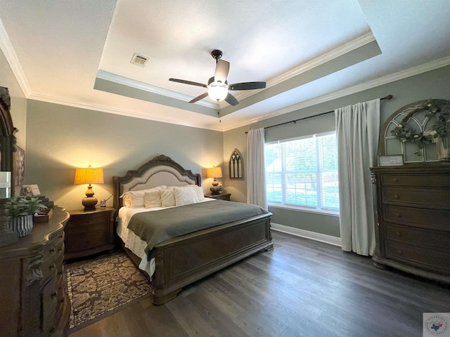 bedroom with ceiling fan, a raised ceiling, crown molding, and dark hardwood / wood-style flooring