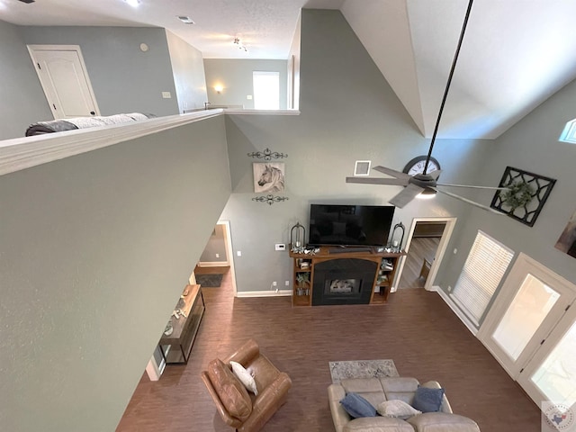 living room with ceiling fan and a high ceiling