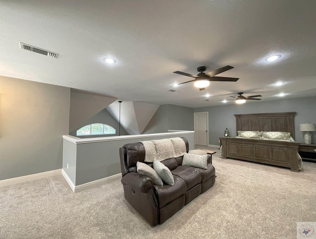 carpeted bedroom featuring a textured ceiling and ceiling fan