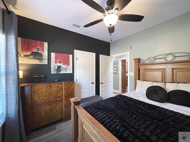 bedroom with ceiling fan and dark wood-type flooring