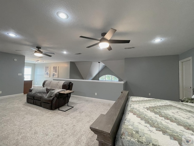 bedroom with ceiling fan, a textured ceiling, and light carpet