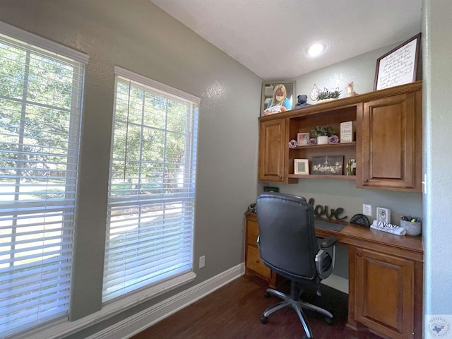 office area with built in desk and dark wood-type flooring