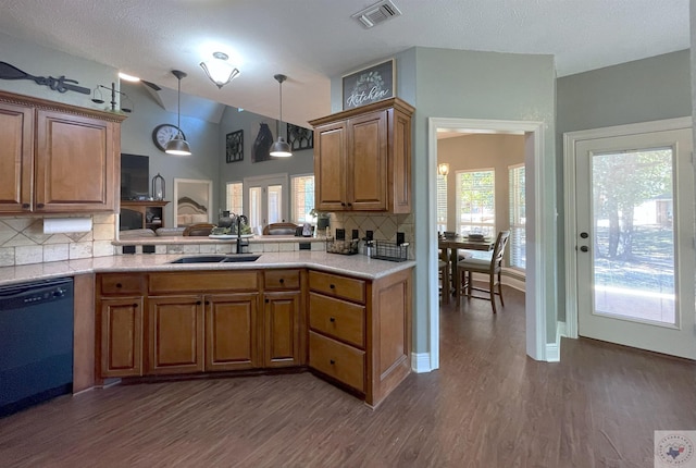 kitchen featuring black dishwasher, tasteful backsplash, sink, dark hardwood / wood-style flooring, and lofted ceiling