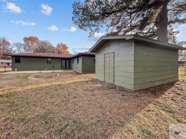 rear view of property with a lawn