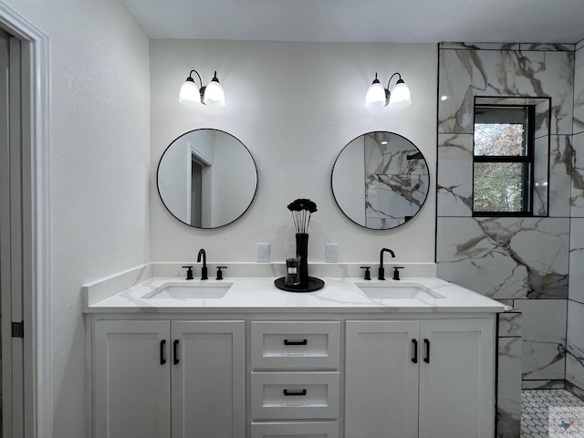 bathroom with vanity and a tile shower