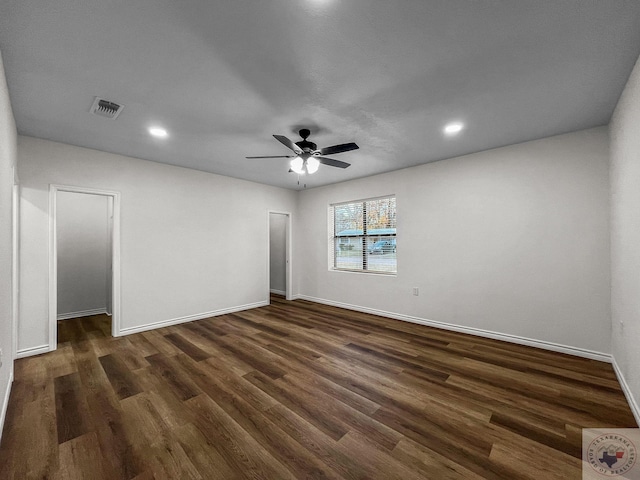 empty room featuring ceiling fan and dark hardwood / wood-style floors