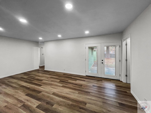 spare room with french doors and dark hardwood / wood-style floors